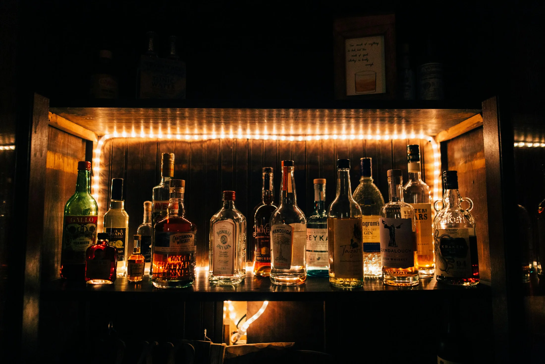 Back-bar shelf of rum, tequila and gin bottles at ABLO Liquor in Calgary